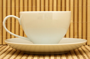 White tea cup on a bamboo background
