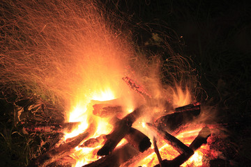 camp fire at night, flame and spark traces, exposure time 8 sec