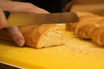 Woman cutting french loaf