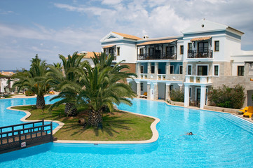 resort with swiming pool and palm tree