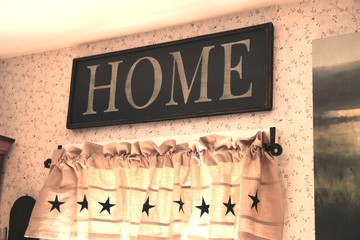 home letter sign displayed on flowered wallpaper 02