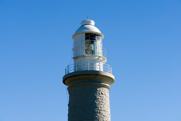 close up lighthouse with view to blue sky