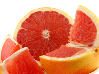 Slices of a grapefruit. A close up. Isolated on a white.