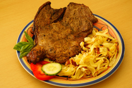 Beef steak with fried pasta