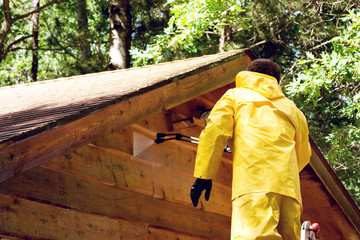 Fototapeta premium a man pressure washing a wood sided garage