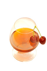 Glass of wine and cherries isolated on white