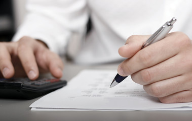 A businessman calculating expenses at tax time