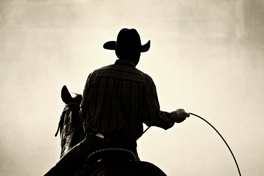 cowboy at the rodeo - shot backlit against dust, added grain