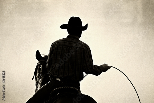 Fototapete Cowboy At The Rodeo Shot Backlit Against Dust Added Grain Sascha Burkard