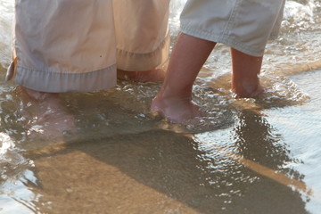 mother and baby feet in water