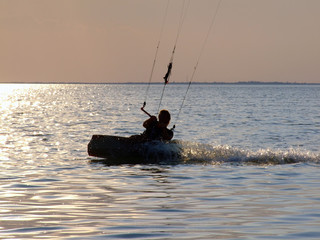 Silhouettes kitesurf on a gulf on a sunset 2