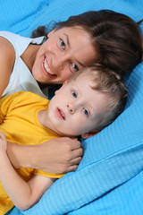 mother and three years old boy in bedroom