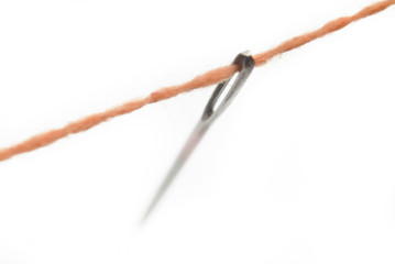 needle eye with an orange string