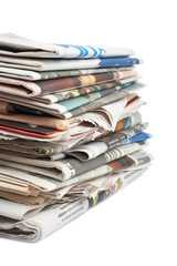 A stack of local newspapers with focus on front. Shallow DOF