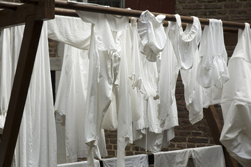 Pair of white cloths hanging to dry in open air.