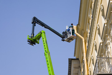 worker renovating the facade