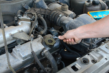 mechanic working on an engine of the car