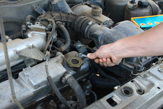 Mechanic Working On An Engine Of The Car