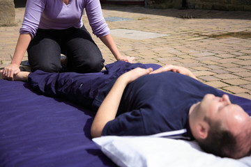 Mobilising the pelvis as part of a Thai body massage.