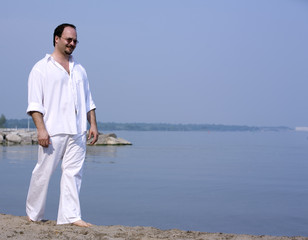 casual man walking on the beach during summer days