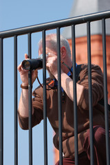 Photographer taking a photo through railings