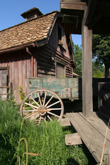 Cart wheel and old barn