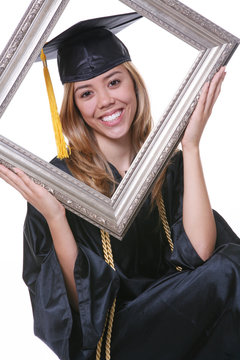 A pretty woman graduating holding a picture frame