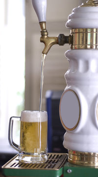 Mug Of Draft Beer Being Filled At The Tap In A Bar