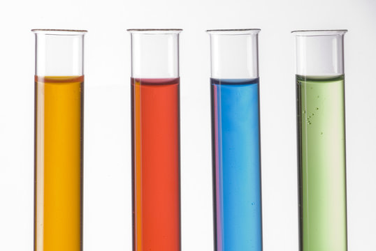 glass test tubes filled with colorful liquids