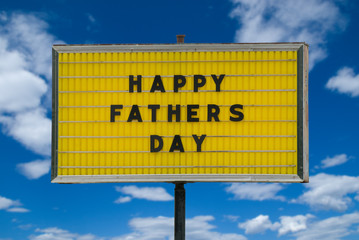 Happy Fathers day message on a yellow sign