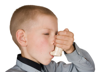 The boy injects an inhaler on an isolated background