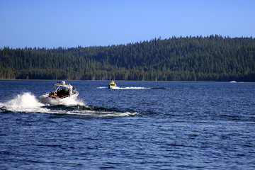 Motor Boats Moving Across the Lake in the Mountains