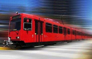 Beautiful red trolley moving fast through downtown