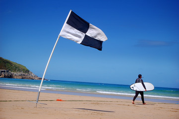 A surfer and surf area flag.