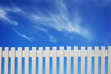 A white fence and blue sky.