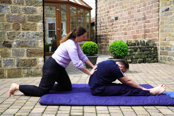 Flexing the spine as part of a Thai body massage.