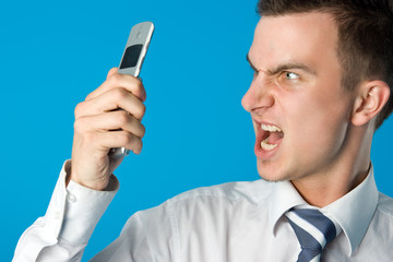 Angry businessman screaming on the mobile phone. 