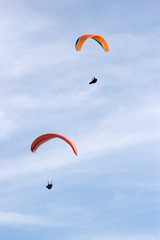a couple of paragliders in the sky