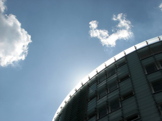 Apartment block silhouetted against cloudy sky.
