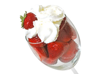 Strawberries and whipped cream in glass. Clipping path.