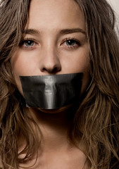 a woman's mouth sealed with a scotch tape