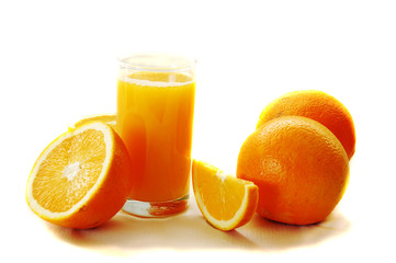 glass of orange juice and oranges