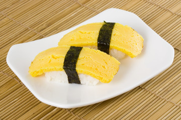 Japanese food - Tamago nigiri on a plate..