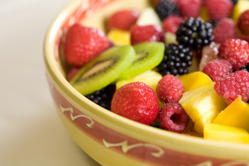 Delicious fruit salad in a bowl with strawberries and kiwi