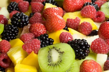Gordijnen Delicious fruit salad served in a bowl © Simone van den Berg