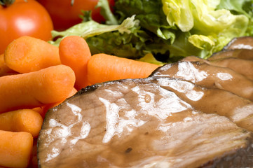 roast beef dinner with whole baby carrots and salad