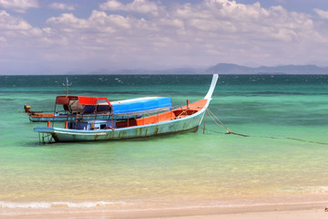 a boat on the colorful andaman sea,  thailand