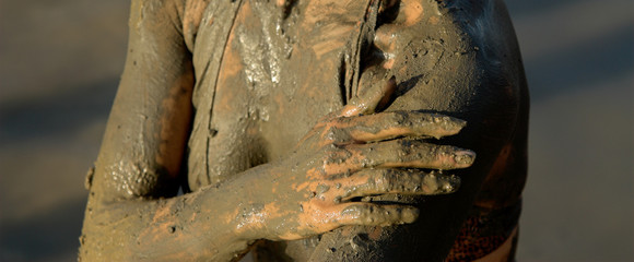 half naked woman add dead sea clay