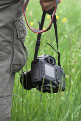 photographer holding a digital SLR camera