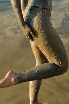 half naked woman add dead sea clay